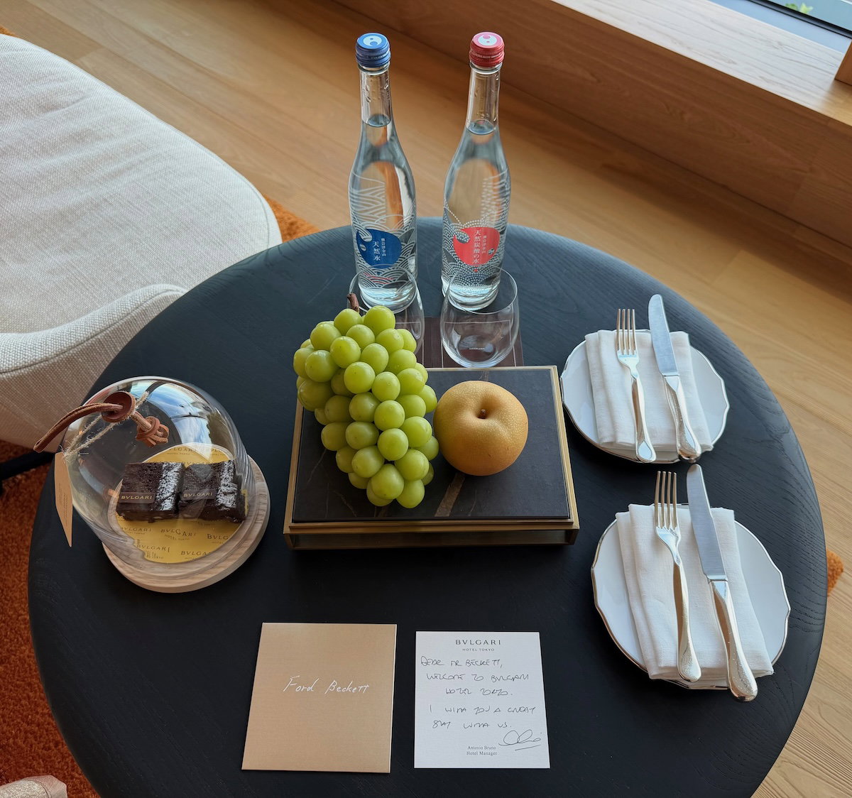 Welcome amenity of fresh fruit, chocolate brownies and bottled water on a table