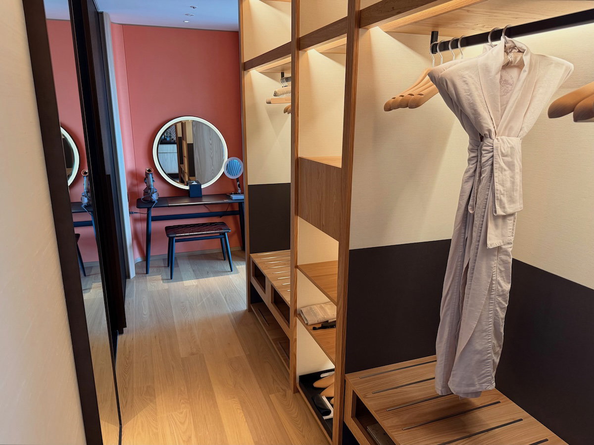 Spacious walk-in closet behind the bedroom area
