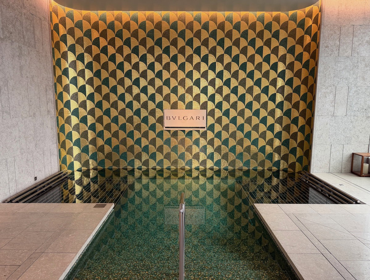 Hot tub with hydrotherapy jets and built-in seating beside the pool