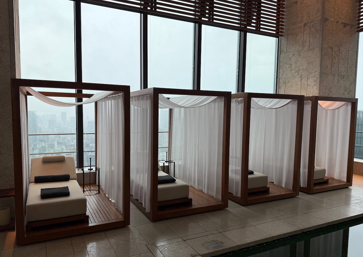 Loungers arranged around the pool, including some semi-private ones
