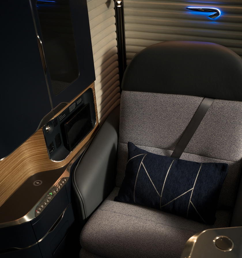 British Airways first class suite with new pillow, bedding, and navy sleepwear