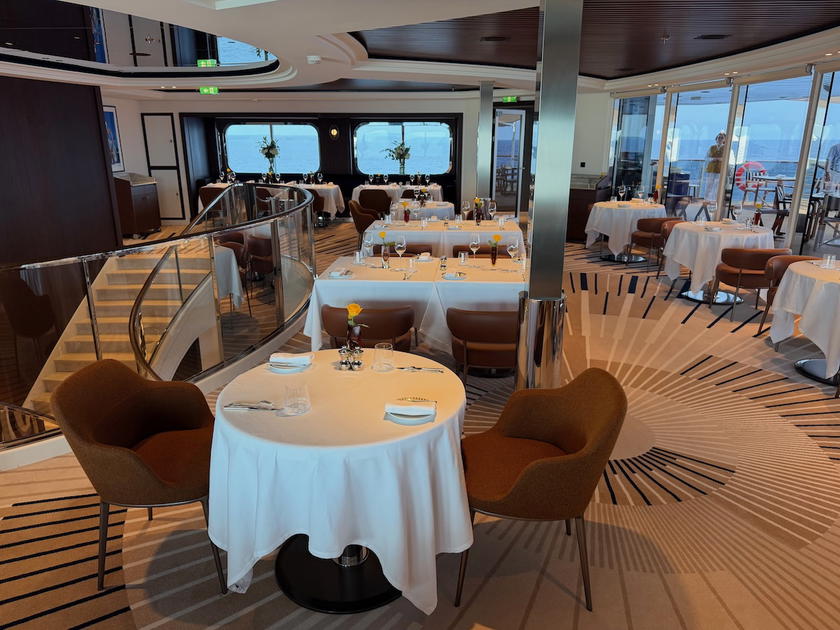 Main restaurant aboard the Corinthian set with white tablecloths