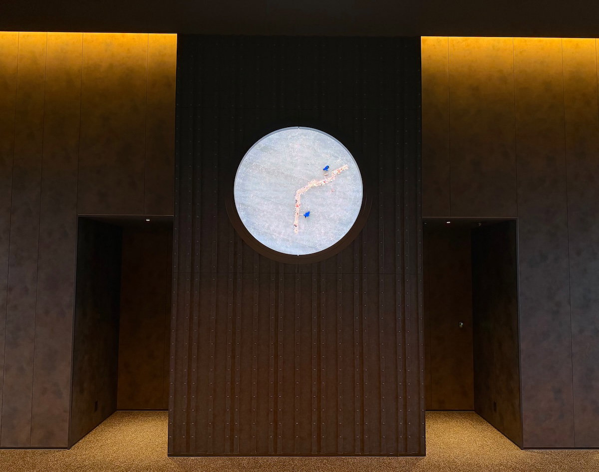 Digital clock in the lobby where people sweeping trash on the dial show the time