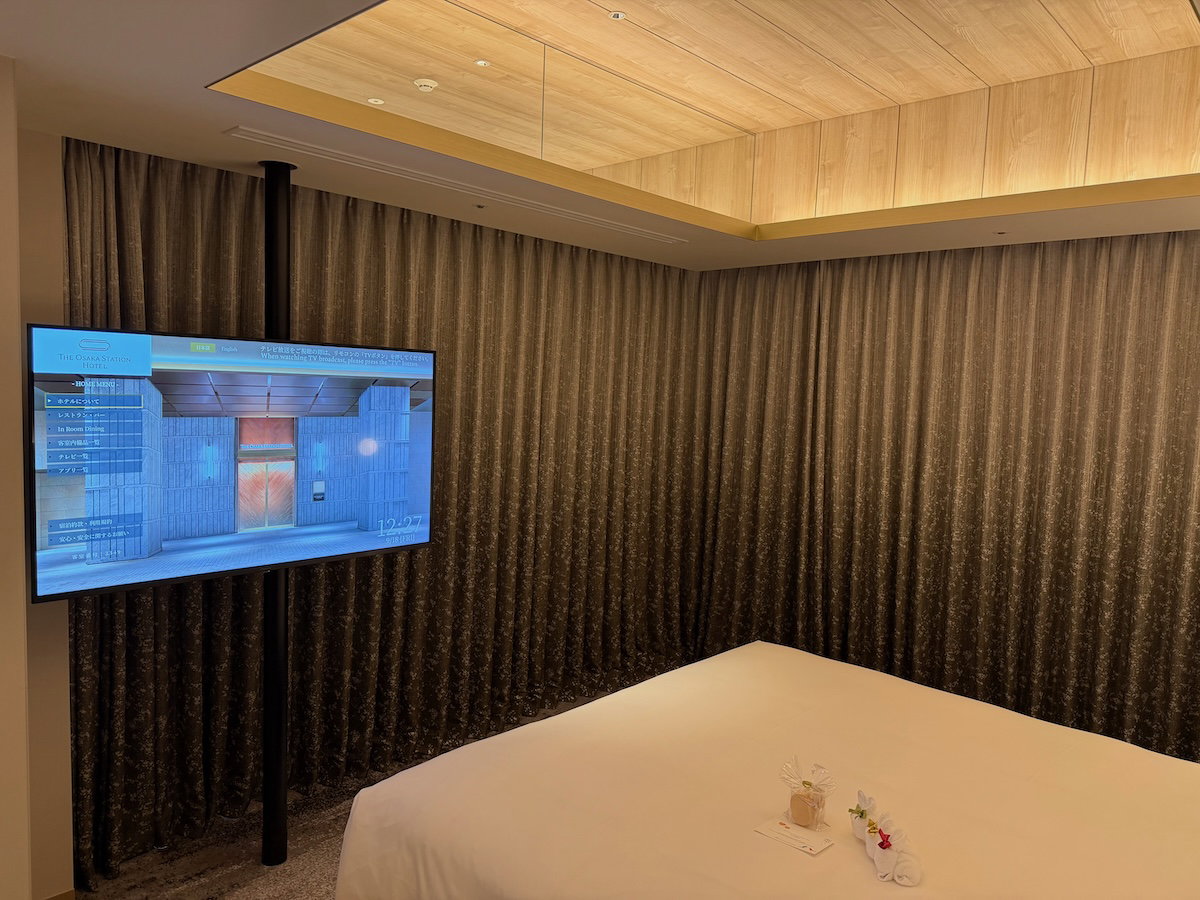 King bed with a TV across from it in the guest room