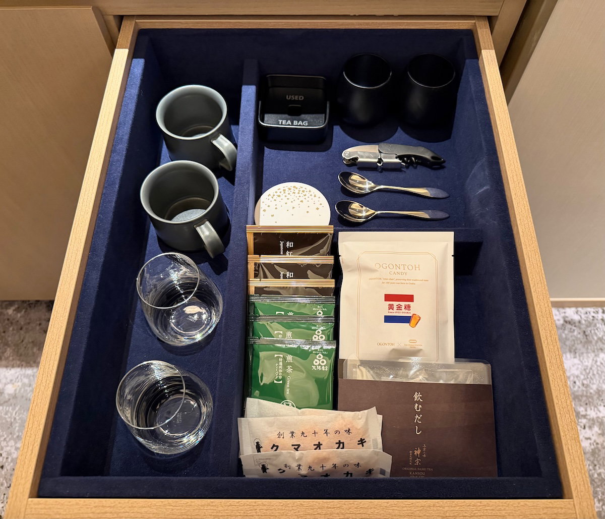 Minibar stocked with water, juice, beer, sake and candy