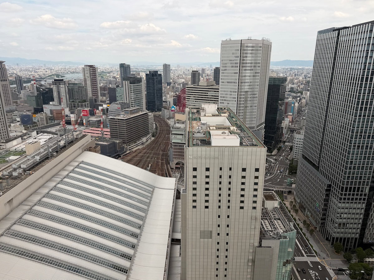 Second view from the guest room window across the Osaka cityscape and rail lines