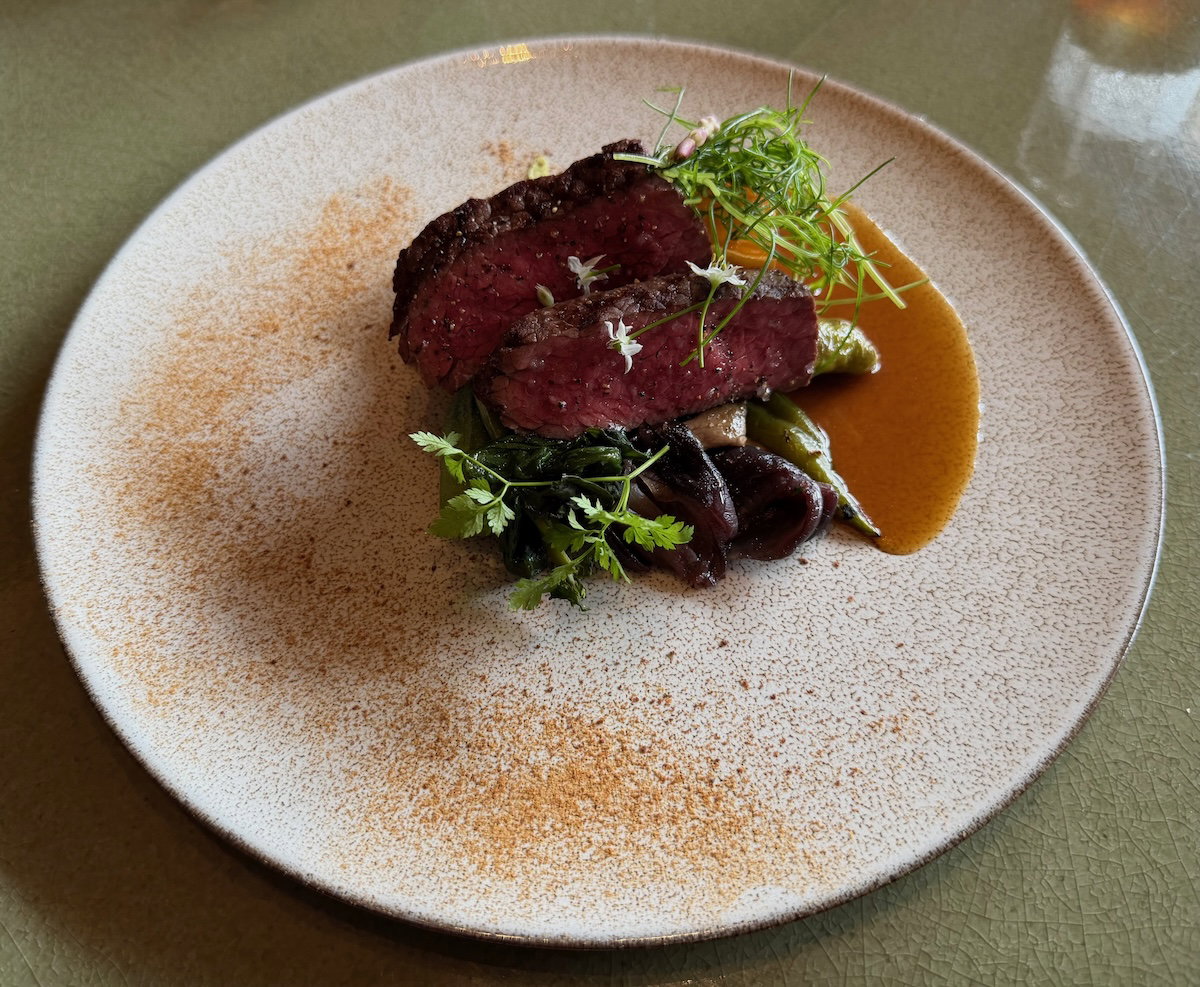 Grilled dry-aged beef rump with vegetables and onion jus at P72