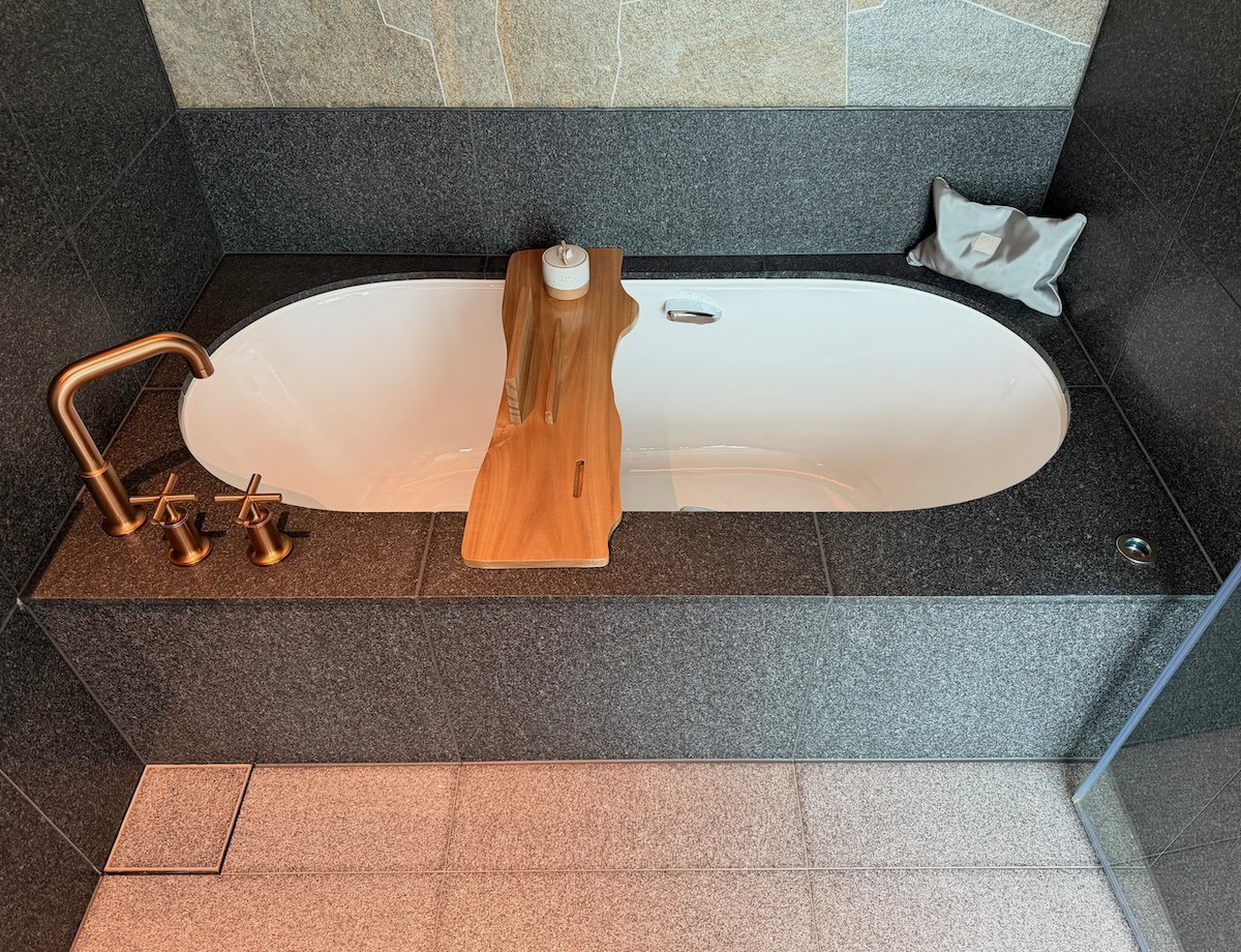 Walk-in shower and bathtub area in the bathroom of a Patina Osaka guest room