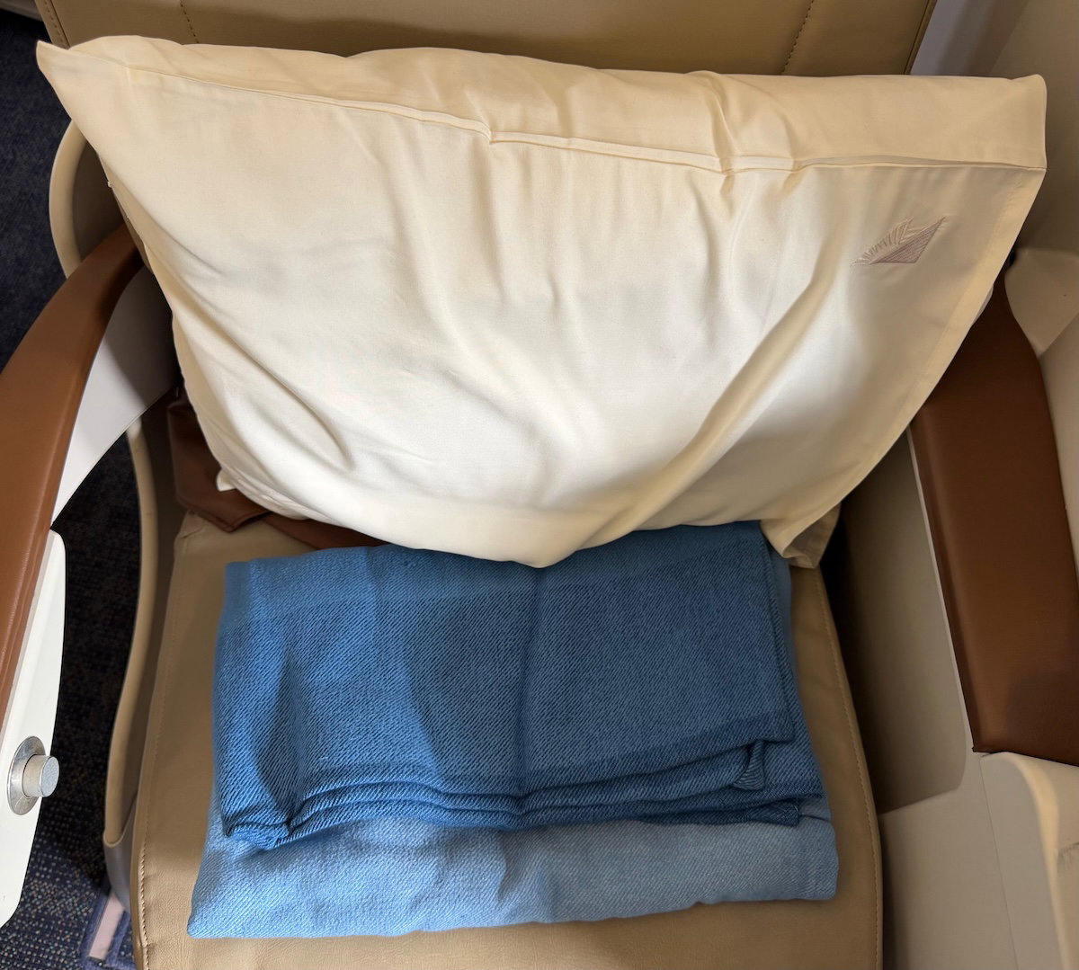 Pillow and blanket placed on a Philippine Airlines business class seat