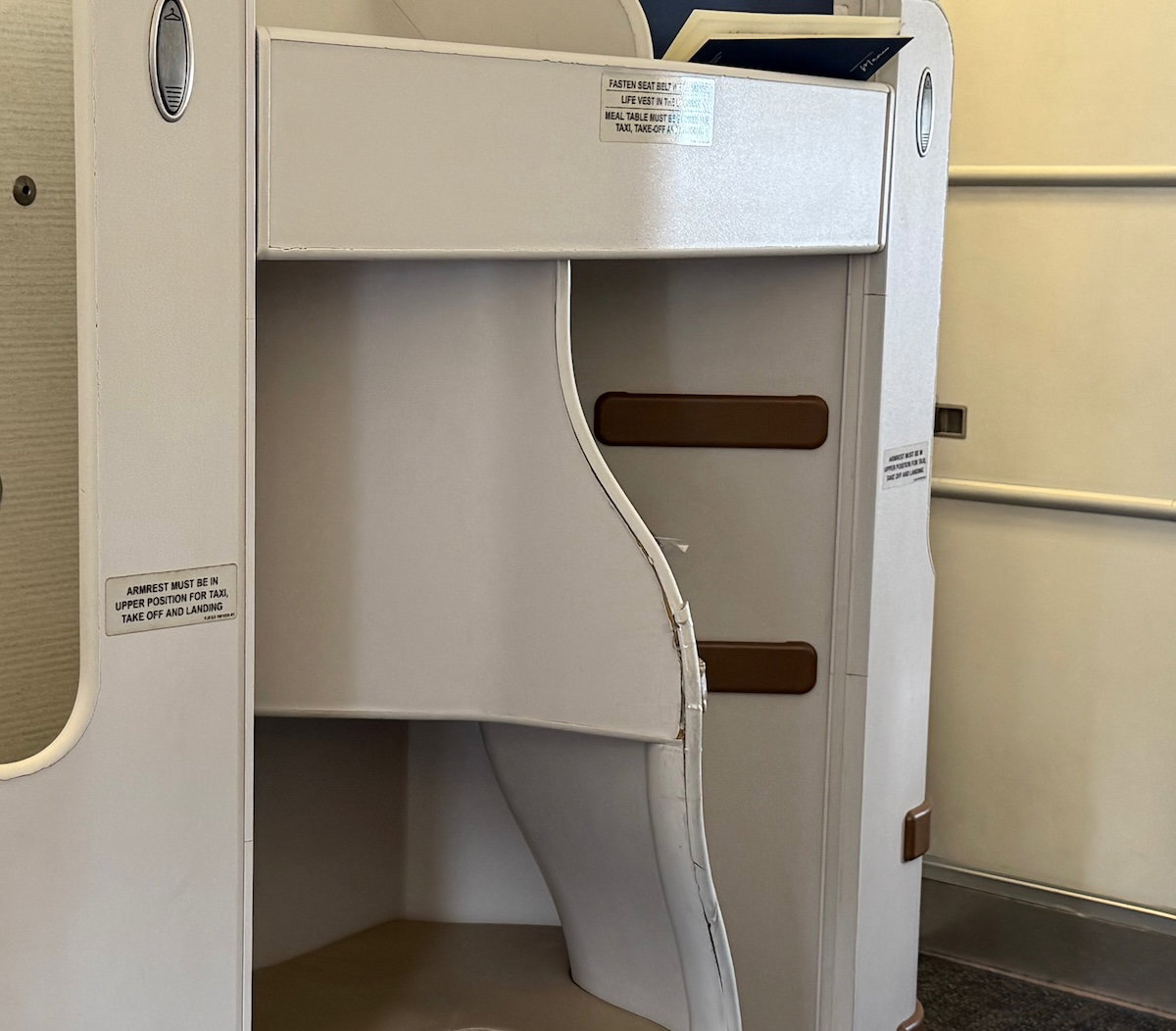 Worn and damaged trim on a Philippine Airlines A330 business class seat