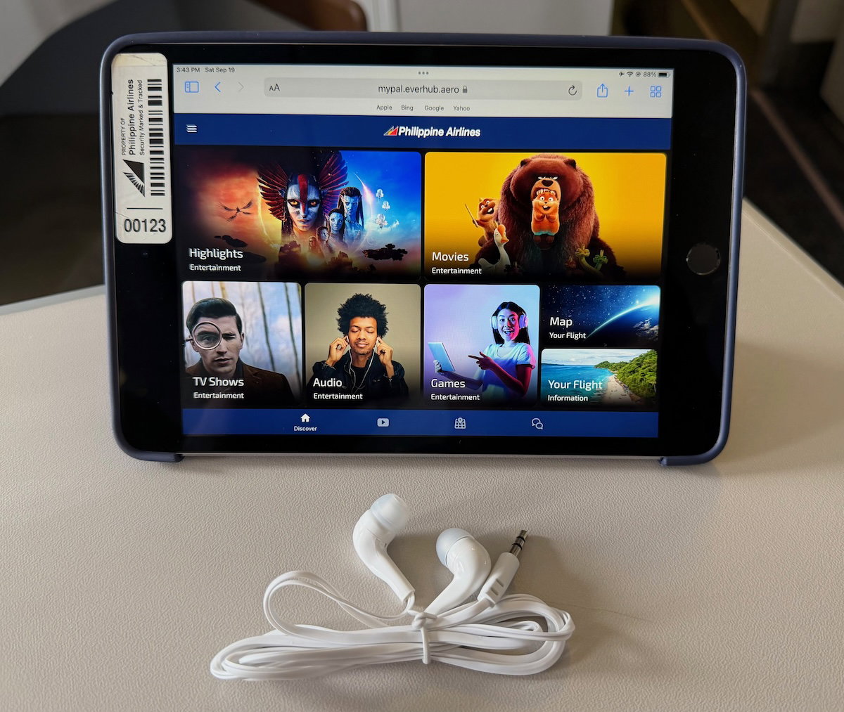 Tablet for streaming entertainment resting on the tray table in Philippine Airlines business class