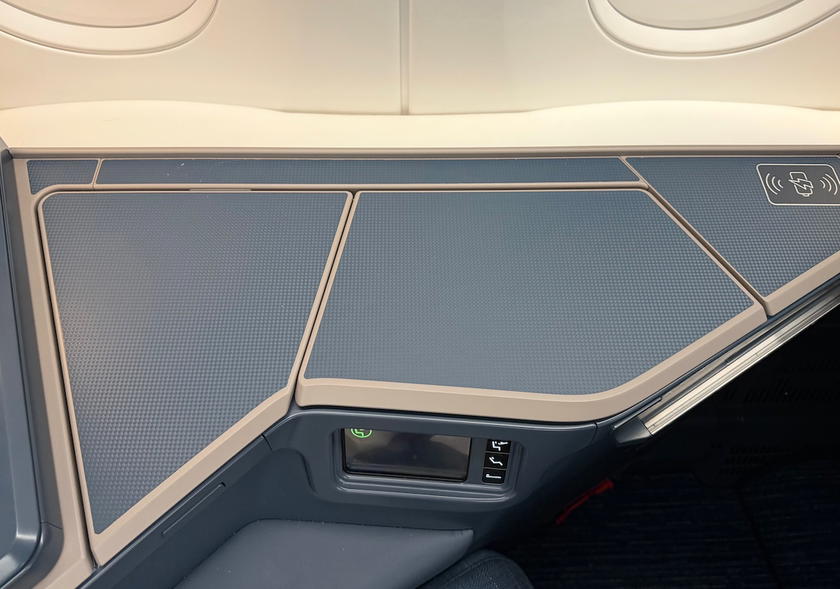 Seat console in Philippine Airlines business class with storage compartment open