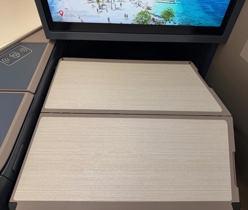 Fold-over tray table extended from beneath the entertainment screen