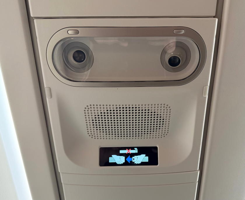 Ceiling above the business class cabin with no overhead bins in the center section