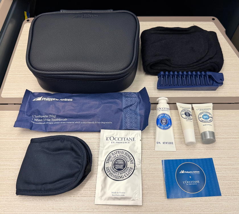 Amenity kit with socks, comb, dental kit, eyeshades and L'Occitane products