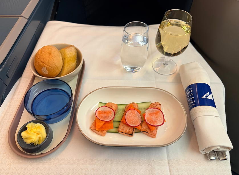 Smoked salmon starter with pickled carrot ribbons, cucumber and radish, plus bread rolls