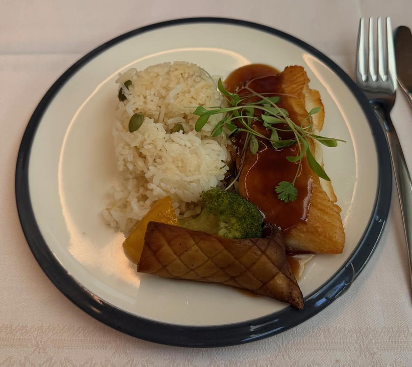 Pan seared halibut main course with vegetables and flavored rice