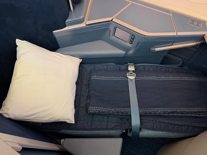 Business class seat reclined into a flat bed with bedding on the Philippine Airlines A350