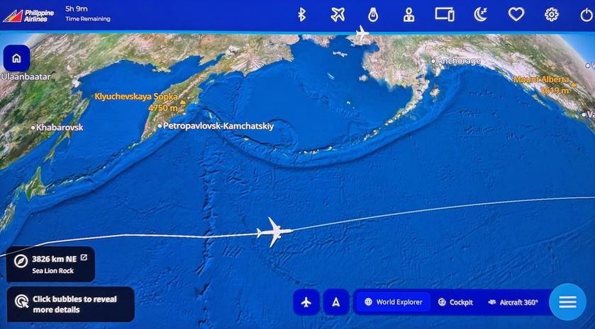 Flight map on the seat screen showing the plane south of the Aleutian Islands