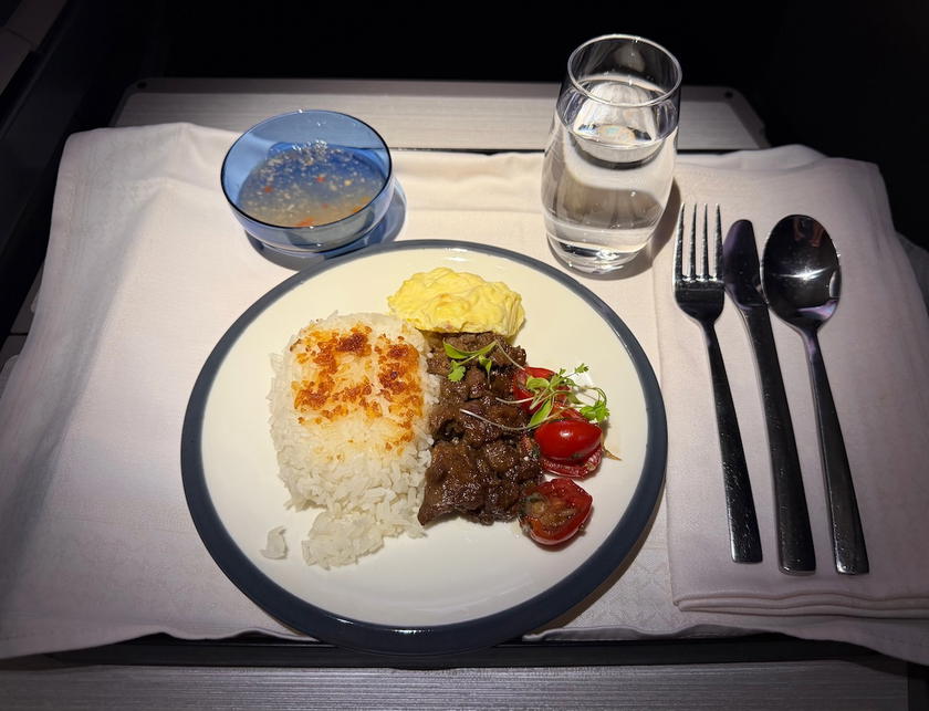 Beef tapa with scrambled eggs, tomato salsa and garlic rice served as a mid-flight snack