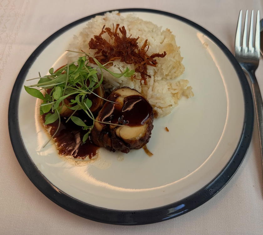 Chicken adobo breakfast main with pickled cucumber, mango and papaya, and rice