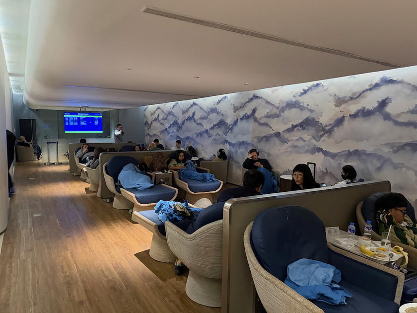 Rows of lounge chairs occupied by passengers in the Mabuhay Lounge