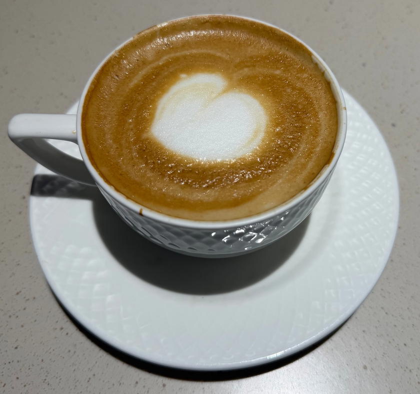 Cappuccino in a cup on a table in the Philippine Airlines lounge in Manila