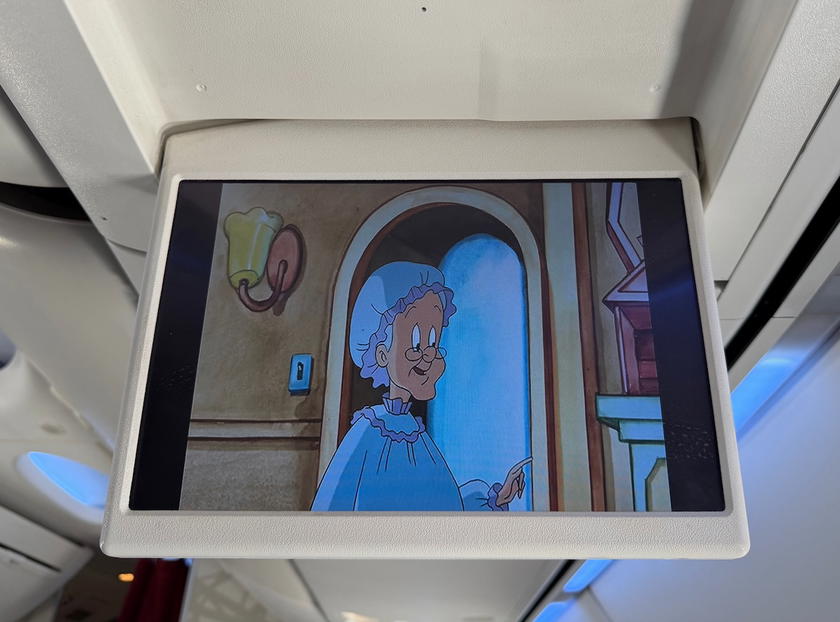 Overhead monitor showing cartoons as inflight entertainment in Royal Air Maroc 737 business class
