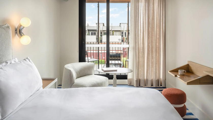 Guest room at The StandardX Melbourne with a bed and compact furnishings