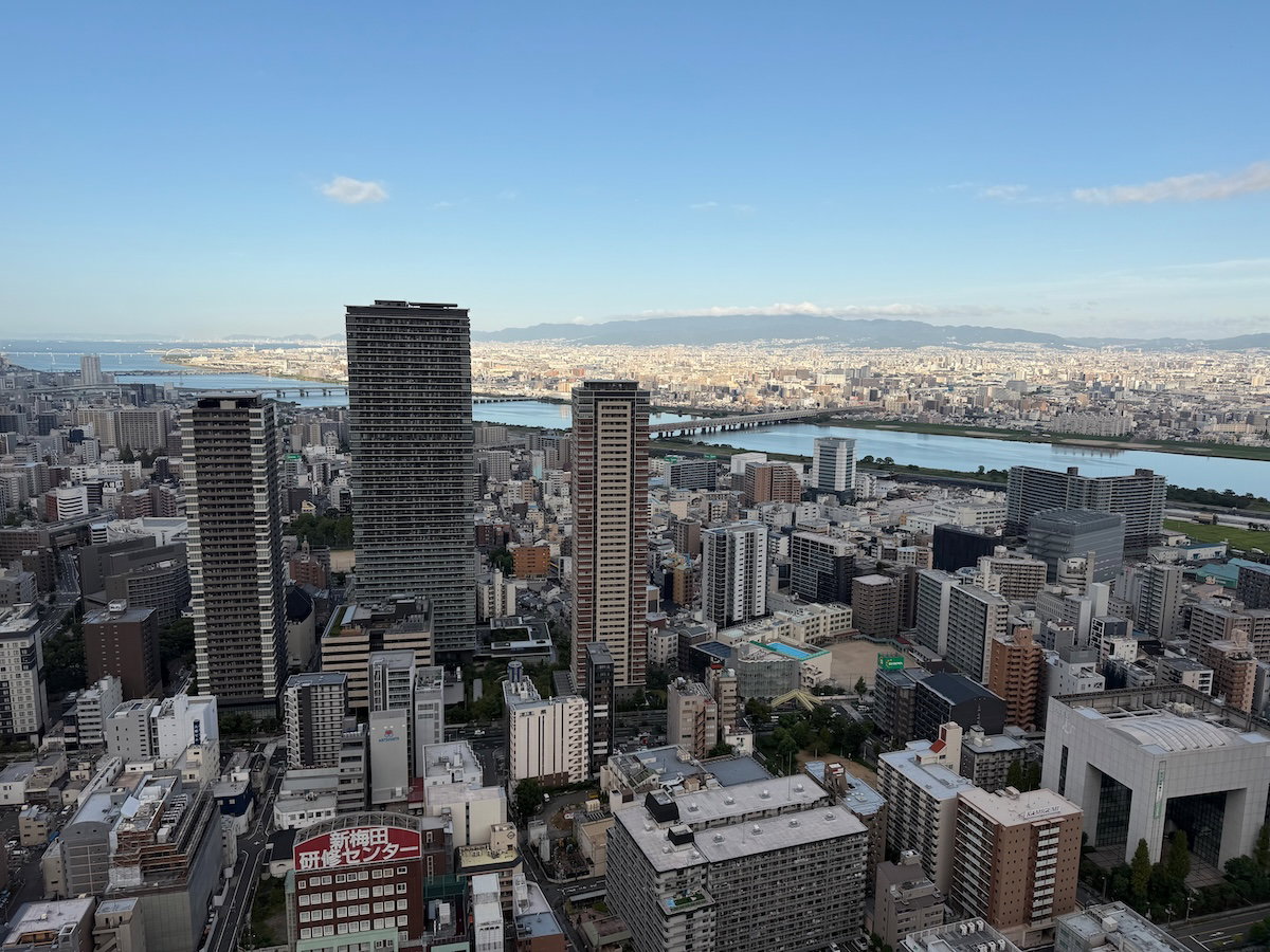View of the Osaka skyline and river from the corner suite bedroom at the Waldorf Astoria Osaka