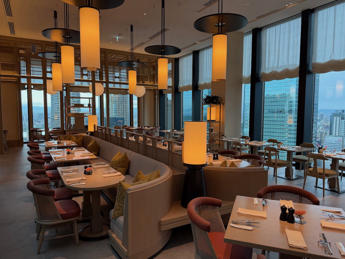 Jolie Brasserie dining room at the Waldorf Astoria Osaka with tables and large windows overlooking the city