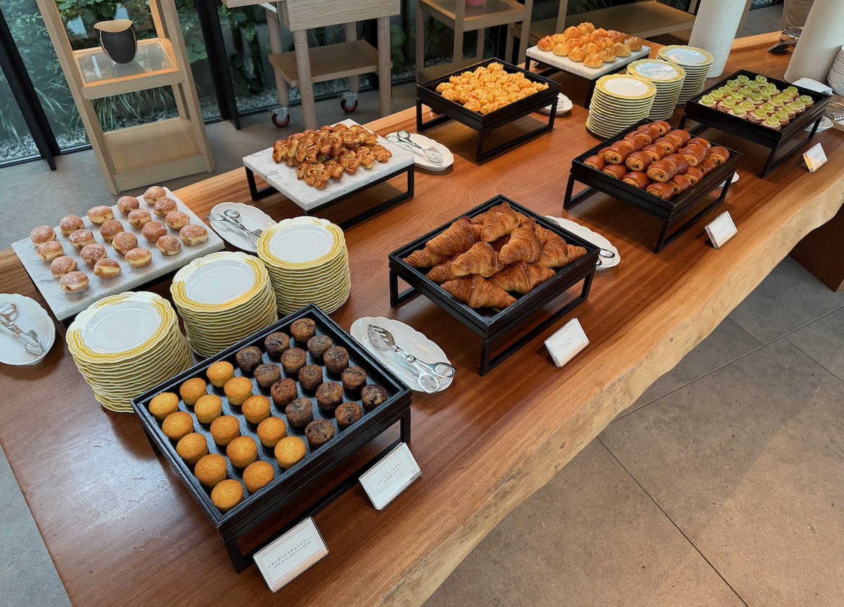 Breakfast buffet display of baked goods and juices at Jolie Brasserie